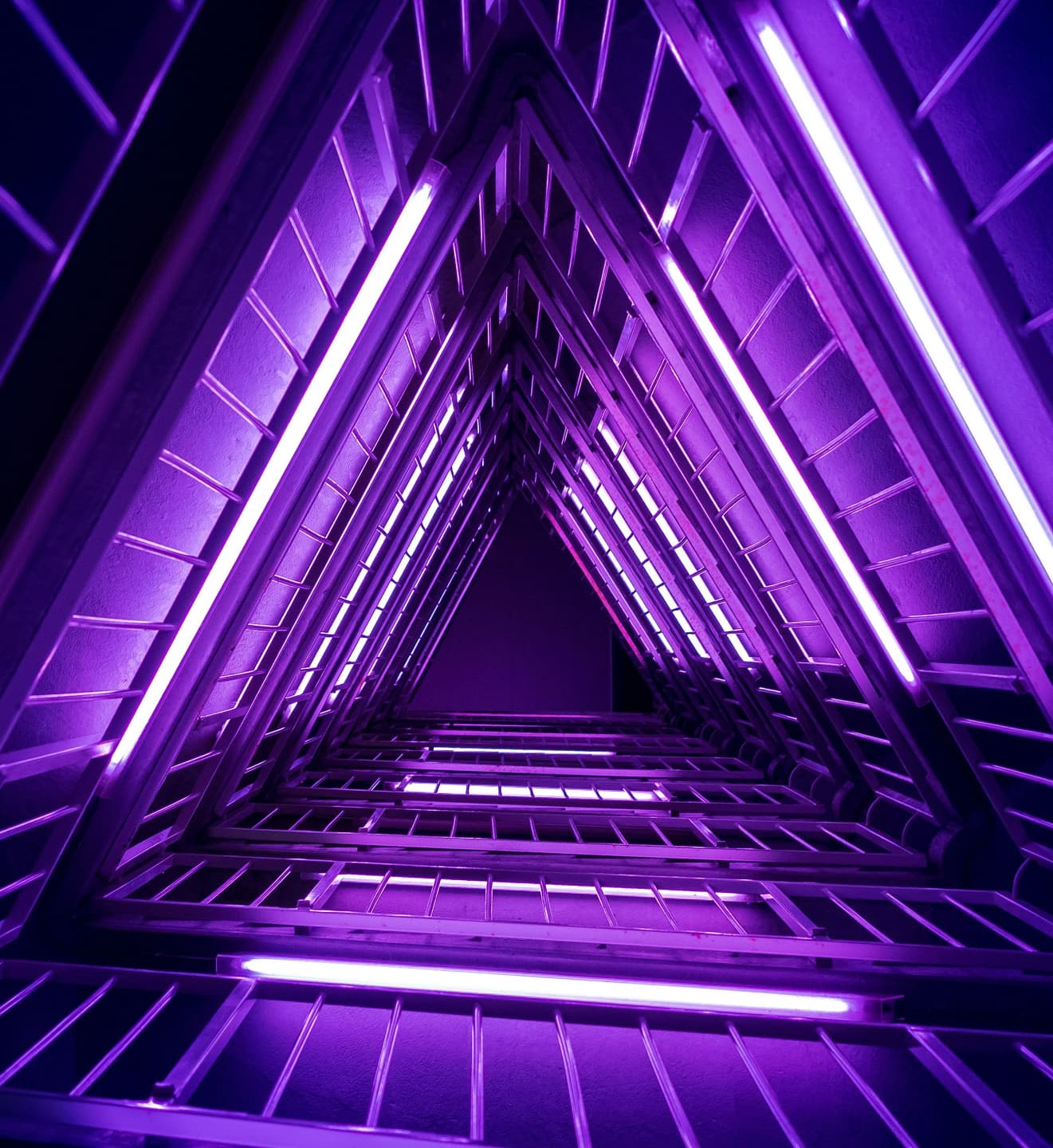 Triangular architecture lit by neon purple lights